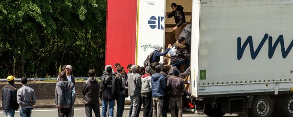 Migrants climb in the back of a lorry on the A16 highway leading to the Eurotunnel on June 23, 2015 in Calais, northern France Migrants climb in the back of a lorry on the A16 highway leading to the Eurotunnel on June 23, 2015 in Calais, northern France - Sputnik International