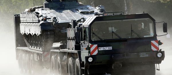A transportation truck carries an armoured transport vehicle during a demonstration event held for the media by the German Bundeswehr. - Sputnik International