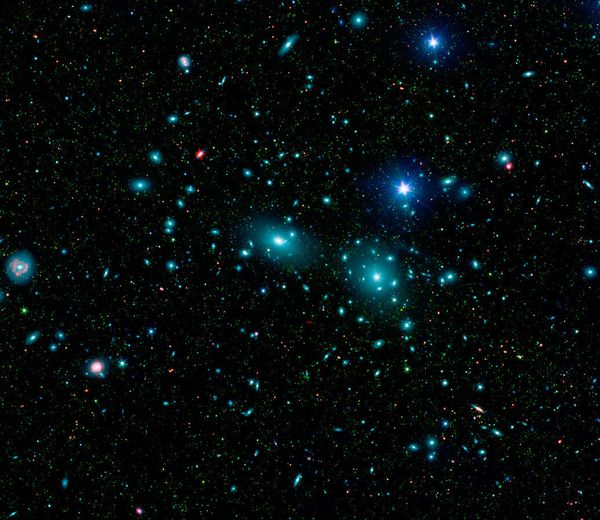 This false-color mosaic of the central region of the Coma cluster combines infrared and visible-light images to reveal thousands of faint objects (green) - Sputnik International