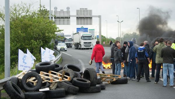 Striking ferry workers burn tyres as they block a ramp leading into the Eurotunnel before being dispersed by riot police in Calais, northern France, Tuesday, June 23, 2015 Striking ferry workers burn tyres as they block a ramp leading into the Eurotunnel before being dispersed by riot police in Calais, northern France, Tuesday, June 23, 2015 - Sputnik International