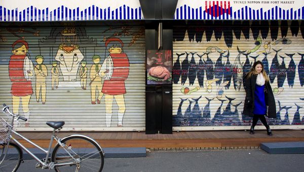 A woman stands in front of a closed shop in the outer part of the Tsukiji fish market, the Jogai Shijo, in Tokyo A woman stands in front of a closed shop in the outer part of the Tsukiji fish market, the Jogai Shijo, in Tokyo - Sputnik International