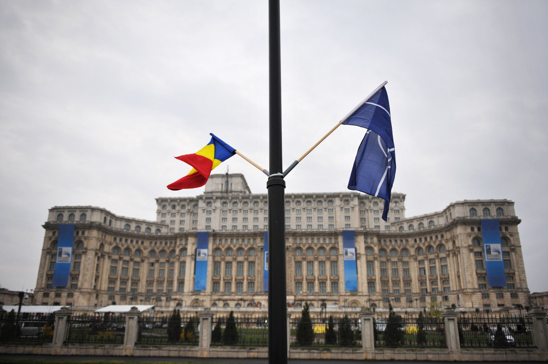 File photo of the Romanian and the NATO flag flutter in the wind in front of the Parliament Palace, the second largest building in the world after the Pentagon, in Bucharest on April 1, 2008 on the eve of the start of the NATO summit taking place form April 2 to 4 File photo of the Romanian and the NATO flag flutter in the wind in front of the Parliament Palace, the second largest building in the world after the Pentagon, in Bucharest on April 1, 2008 on the eve of the start of the NATO summit taking place form April 2 to 4 - Sputnik International, 1920, 21.08.2022