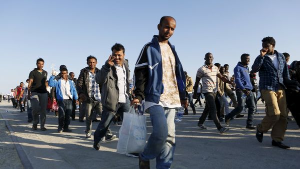 Migrants walk after disembarking from the Spanish Civil Guard's ship Rio Segura, in the Sicilian harbour of Augusta, Italy, June 23, 2015 Migrants walk after disembarking from the Spanish Civil Guard's ship Rio Segura, in the Sicilian harbour of Augusta, Italy, June 23, 2015 - Sputnik International