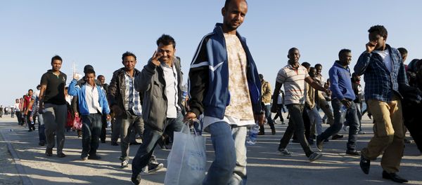 Migrants walk after disembarking from the Spanish Civil Guard's ship Rio Segura, in the Sicilian harbour of Augusta, Italy, June 23, 2015 Migrants walk after disembarking from the Spanish Civil Guard's ship Rio Segura, in the Sicilian harbour of Augusta, Italy, June 23, 2015 - Sputnik International