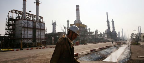 An Iranian oil worker makes his way through Tehran's oil refinery south of the capital Tehran, Iran, Monday, Dec. 22, 2014 An Iranian oil worker makes his way through Tehran's oil refinery south of the capital Tehran, Iran, Monday, Dec. 22, 2014 - Sputnik International
