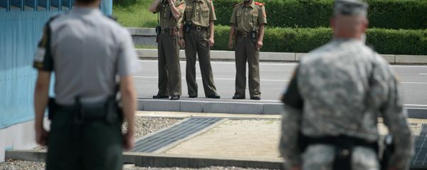 North Korean soldiers (C) take photos towards a South Korean soldier (L) and a US soldier (R) standing before the military demarcation line (lower C) seperating North and South Korea within the Joint Security Area (JSA) at Panmunjom on July 27, 2014 North Korean soldiers (C) take photos towards a South Korean soldier (L) and a US soldier (R) standing before the military demarcation line (lower C) seperating North and South Korea within the Joint Security Area (JSA) at Panmunjom on July 27, 2014 - Sputnik International