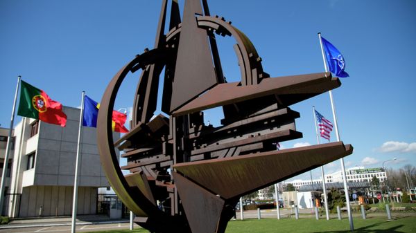 The NATO symbol and flags of the NATO nations outside NATO headquarters in Brussels on Sunday, March 2, 2014 The NATO symbol and flags of the NATO nations outside NATO headquarters in Brussels on Sunday, March 2, 2014 - Sputnik International