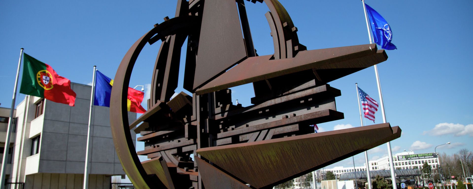 The NATO symbol and flags of the NATO nations outside NATO headquarters in Brussels on Sunday, March 2, 2014 - Sputnik International, 1920, 19.06.2023