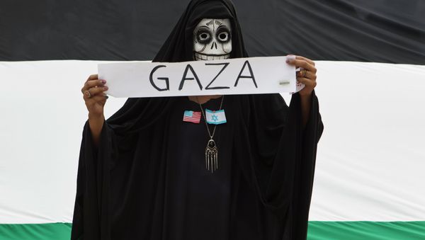 A protester wears a skull face mask during a protest against Israel's military action in the Gaza Strip, in Mexico City, Saturday, Aug. 9, 2014. - Sputnik International