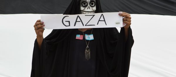 A protester wears a skull face mask during a protest against Israel's military action in the Gaza Strip, in Mexico City, Saturday, Aug. 9, 2014. - Sputnik International
