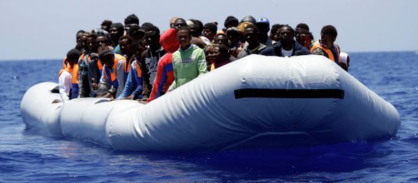 A rubber boat loaded of migrants is seen during a search and rescue mission in the mediterranean sea off the Libyan coasts, Italy, Tuesday, June 23, 2015 - Sputnik International