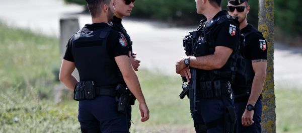Police officers guard the road leading to a plant where an attack took place in Saint-Quentin-Fallavier, southeast of Lyon, France, Friday, June 26, 2015 - Sputnik International