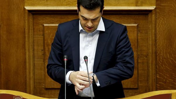 Greek Prime Minister Alexis Tsipras looks at his watch as he delivers a speech during a parliamentary session in Athens, Greece in this June 28, 2015 - Sputnik International