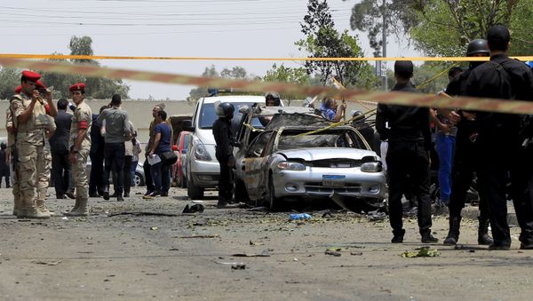 Policemen and army forces are seen at the site of a car bomb attack on the convoy of Egyptian public prosecutor Hisham Barakat near his house at Heliopolis district in Cairo, Egypt Policemen and army forces are seen at the site of a car bomb attack on the convoy of Egyptian public prosecutor Hisham Barakat near his house at Heliopolis district in Cairo, Egypt - Sputnik International