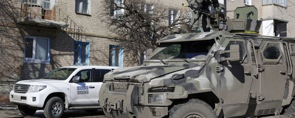A Ukrainian serviceman stands on top of a KRAZ armoured vehicle close to a car of the Organization for Security and Cooperation in Europe (OSCE) in Soledar, Donetsk region. (File) A Ukrainian serviceman stands on top of a KRAZ armoured vehicle close to a car of the Organization for Security and Cooperation in Europe (OSCE) in Soledar, Donetsk region. (File) - Sputnik International