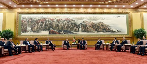 Chinese President Xi Jinping, center right, speaks to Swiss Economy Minister Johann Schneider-Ammann as he meets with delegates attending the signing ceremony for the Articles of Agreement of the Asian Infrastructure Investment Bank (AIIB) at the Great Hall of the People in Beijing Chinese President Xi Jinping, center right, speaks to Swiss Economy Minister Johann Schneider-Ammann as he meets with delegates attending the signing ceremony for the Articles of Agreement of the Asian Infrastructure Investment Bank (AIIB) at the Great Hall of the People in Beijing - Sputnik International