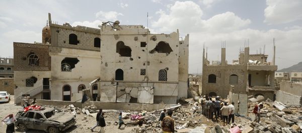 People walk on the rubble of houses destroyed by a Saudi-led air strike People walk on the rubble of houses destroyed by a Saudi-led air strike - Sputnik International