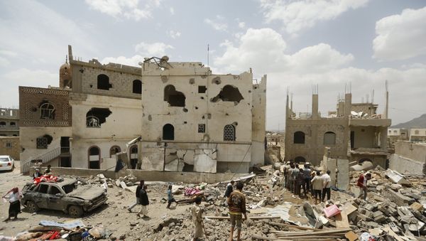 People walk on the rubble of houses destroyed by a Saudi-led air strike People walk on the rubble of houses destroyed by a Saudi-led air strike - Sputnik International