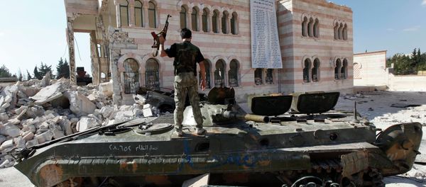 Free Syrian Army soldier stands on a damaged Syrian military tank in front of a damaged mosque, which were destroyed during fighting with government forces, in the Syrian town of Azaz. Free Syrian Army soldier stands on a damaged Syrian military tank in front of a damaged mosque, which were destroyed during fighting with government forces, in the Syrian town of Azaz. - Sputnik International