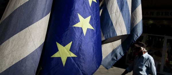 A man walks past a European and Greek flags in central Athens, on Tuesday, June 30, 2015. A man walks past a European and Greek flags in central Athens, on Tuesday, June 30, 2015. - Sputnik International