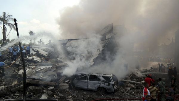 Firemen and security forces attempt to extinguish the fire surrounding the wreckage of an Indonesian military transport plane after it crashed in the North Sumatra city of Medan, Indonesia June 30, 2015 in this photo taken by Antara Foto Firemen and security forces attempt to extinguish the fire surrounding the wreckage of an Indonesian military transport plane after it crashed in the North Sumatra city of Medan, Indonesia June 30, 2015 in this photo taken by Antara Foto - Sputnik International
