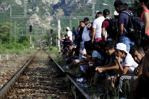 Migrants wait beside railway tracks for trains at Demir Kapia train station in Macedonia, near the border with Greece Migrants wait beside railway tracks for trains at Demir Kapia train station in Macedonia, near the border with Greece - Sputnik International