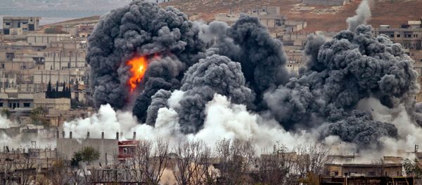 Smoke rises from the Syrian city of Kobani, following an airstrike by the US led coalition, seen from a hilltop outside Suruc, on the Turkey-Syria border Monday, Nov. 17, 2014. - Sputnik International