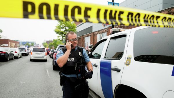 A police officer speaks on his phone as a large police presence gathers along M St. in Southeast Washington, Thursday, July 2, 2015, after an official said shots have been reported in a building on the Washington Navy Yard campus A police officer speaks on his phone as a large police presence gathers along M St. in Southeast Washington, Thursday, July 2, 2015, after an official said shots have been reported in a building on the Washington Navy Yard campus - Sputnik International
