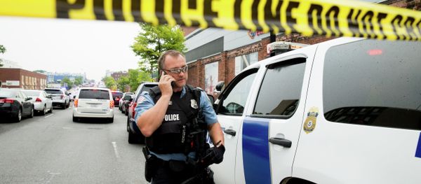 A police officer speaks on his phone as a large police presence gathers along M St. in Southeast Washington, Thursday, July 2, 2015, after an official said shots have been reported in a building on the Washington Navy Yard campus A police officer speaks on his phone as a large police presence gathers along M St. in Southeast Washington, Thursday, July 2, 2015, after an official said shots have been reported in a building on the Washington Navy Yard campus - Sputnik International