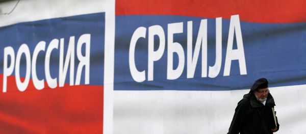 A man walks past by billboards reading Russia, left and Serbia, in Belgrade, Serbia, Friday, Oct. 17, 2014 - Sputnik International