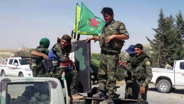 In this photo provided by the Kurdish fighters of the People's Protection Units (YPG), which has been authenticated based on its contents and other AP reporting, Kurdish fighters of the YPG, sit on their pickup in the town of Ein Eissa, north of Raqqa city, Syria, Tuesday, June 23, 2015 In this photo provided by the Kurdish fighters of the People's Protection Units (YPG), which has been authenticated based on its contents and other AP reporting, Kurdish fighters of the YPG, sit on their pickup in the town of Ein Eissa, north of Raqqa city, Syria, Tuesday, June 23, 2015 - Sputnik International