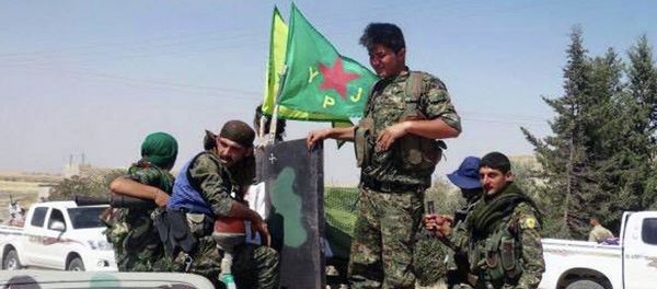 In this photo provided by the Kurdish fighters of the People's Protection Units (YPG), which has been authenticated based on its contents and other AP reporting, Kurdish fighters of the YPG, sit on their pickup in the town of Ein Eissa, north of Raqqa city, Syria, Tuesday, June 23, 2015 In this photo provided by the Kurdish fighters of the People's Protection Units (YPG), which has been authenticated based on its contents and other AP reporting, Kurdish fighters of the YPG, sit on their pickup in the town of Ein Eissa, north of Raqqa city, Syria, Tuesday, June 23, 2015 - Sputnik International