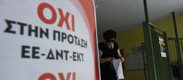 An elderly woman leaves from a polling station as the poster reading ''No to the proposal of EU-IMF-ECB'' in the northern Greek port city of Thessaloniki, Sunday, July 5, 2015 - Sputnik International