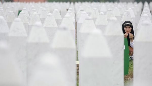 Bosnian woman Merima Nukic prays at the grave of her father during a funeral ceremony at the memorial center in Potocari, near Srebrenica, 160 kms east of Sarajevo, Bosnia - Sputnik International