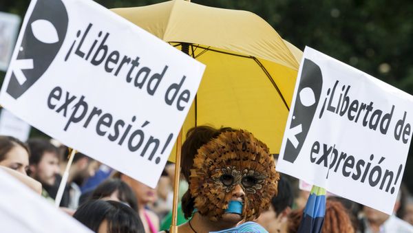 A woman, with her mouth taped, wears a mask during a protest against Spanish government's new security law in central Madrid, Spain - Sputnik International