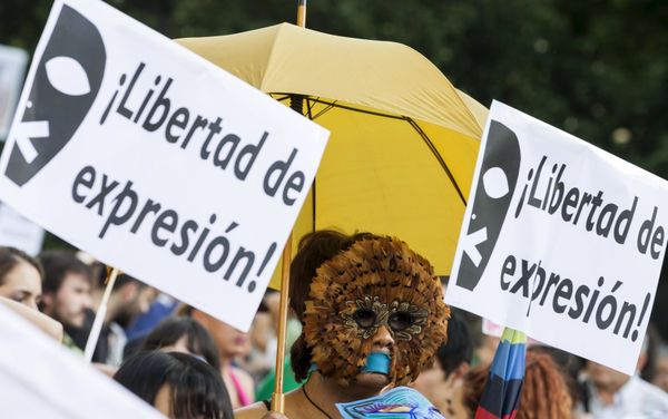 A woman, with her mouth taped, wears a mask during a protest against Spanish government's new security law in central Madrid, Spain A woman, with her mouth taped, wears a mask during a protest against Spanish government's new security law in central Madrid, Spain - Sputnik International