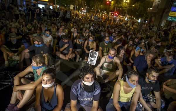 Demonstrators with their mouths taped sit outside the Spanish parliament during a protest against Spanish government's new security law in central Madrid, Spain Demonstrators with their mouths taped sit outside the Spanish parliament during a protest against Spanish government's new security law in central Madrid, Spain - Sputnik International