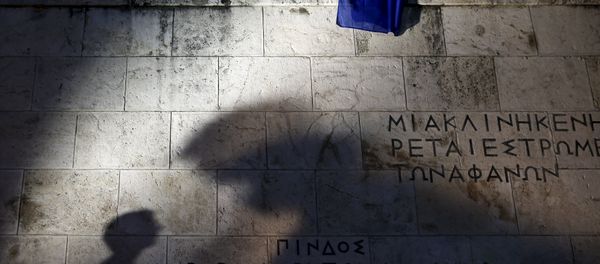An European Union flag is pictured as people are silhouetted on the Tomb of the Unknown Soldier during a rally in front of the Greek parliament An European Union flag is pictured as people are silhouetted on the Tomb of the Unknown Soldier during a rally in front of the Greek parliament - Sputnik International