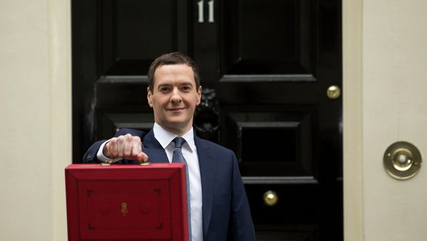 British Chancellor of the Exchequer George Osborne poses for the media with the traditional red dispatch box outside his official residence, 11 Downing Street in London, prior to unveiling the budget, Wednesday, July 8, 2015. British Chancellor of the Exchequer George Osborne poses for the media with the traditional red dispatch box outside his official residence, 11 Downing Street in London, prior to unveiling the budget, Wednesday, July 8, 2015. - Sputnik International