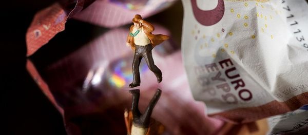 This illustration picture taken in Paris on July 7, 2015 shows a plastic figurine set in the motion of running from underneath a 10 Euro note. This illustration picture taken in Paris on July 7, 2015 shows a plastic figurine set in the motion of running from underneath a 10 Euro note. - Sputnik International