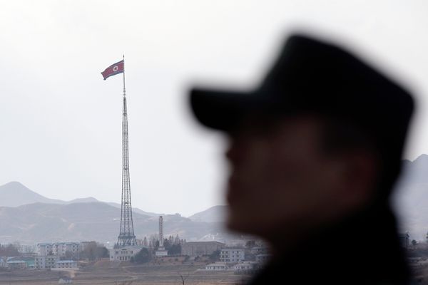 A South Korean soldier stands as a North Korean flag flutters in the wind atop a 160-meter (533-foot) tower in the village of Gijungdong near the north side of the border village of Panmunjom, which has separated the two Koreas since the Korean War, in Paju, north of Seoul, South Korea, Wednesday, Nov. 12, 2014 A South Korean soldier stands as a North Korean flag flutters in the wind atop a 160-meter (533-foot) tower in the village of Gijungdong near the north side of the border village of Panmunjom, which has separated the two Koreas since the Korean War, in Paju, north of Seoul, South Korea, Wednesday, Nov. 12, 2014 - Sputnik International