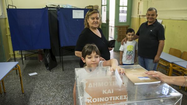 A child casts her grandmother's ballot during a referendum vote in Athens, Greece, July 5, 2015 A child casts her grandmother's ballot during a referendum vote in Athens, Greece, July 5, 2015 - Sputnik International
