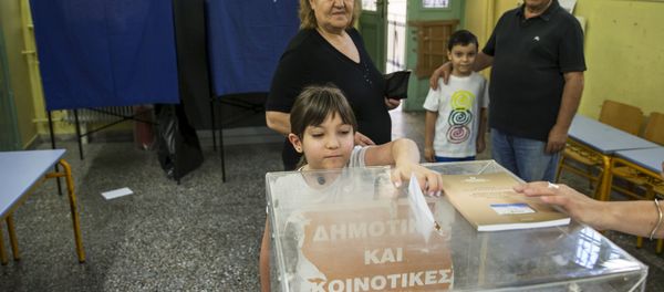 A child casts her grandmother's ballot during a referendum vote in Athens, Greece, July 5, 2015 A child casts her grandmother's ballot during a referendum vote in Athens, Greece, July 5, 2015 - Sputnik International