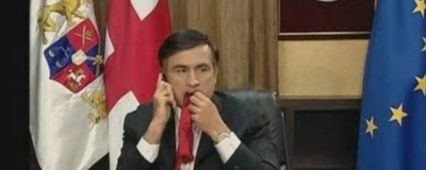 Activists in the city of Ukrainian port city of Odessa are continuing their protest campaign against newly appointed Governor Mikheil Saakashvili, this time launching a giant red balloon featuring his image and the phrase 'Mishko Go Home!', complete with a large red necktie dangling from his mouth. Photo: Saakashvili chewing on his tie as he waits for an interview with the BBC. - Sputnik International