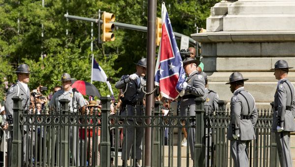 The Confederate battle flag is permanently removed from the South Carolina statehouse grounds during a ceremony in Columbia, South Carolina, July, 10, 2015 - Sputnik International