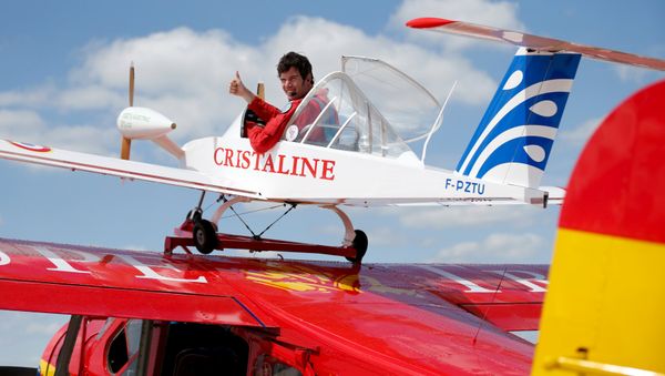 Pilot Hugues Duval in his twin-engined Cri-Cri, one of the world's smallest electrical planes, waits to take off from an old Broussard aircraft, on which it is attached to, during a flying display at the 51st Paris Air Show at Le Bourget airport near Paris, June 19, 2015 Pilot Hugues Duval in his twin-engined Cri-Cri, one of the world's smallest electrical planes, waits to take off from an old Broussard aircraft, on which it is attached to, during a flying display at the 51st Paris Air Show at Le Bourget airport near Paris, June 19, 2015 - Sputnik International