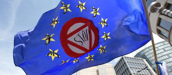 A flag which says stop and has euro money signs in the EU stars flaps in the wind during a protest march in solidarity with Greece in the center of Brussels on Sunday, June 21, 2015 A flag which says stop and has euro money signs in the EU stars flaps in the wind during a protest march in solidarity with Greece in the center of Brussels on Sunday, June 21, 2015 - Sputnik International