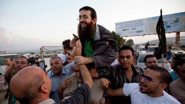 Palestinian Khader Adnan, center, is greeted by Palestinians after his release from an Israeli prison in the West Bank village of Arrabeh near Jenin, Sunday, July 12, 2015 Palestinian Khader Adnan, center, is greeted by Palestinians after his release from an Israeli prison in the West Bank village of Arrabeh near Jenin, Sunday, July 12, 2015 - Sputnik International
