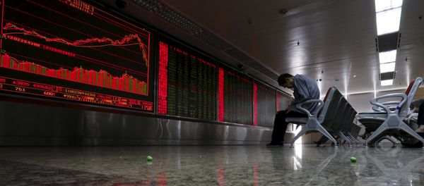 An investor takes notes as he watches a board showing stock prices at a brokerage office in Beijing, China, in this July 6, 2015 file photo An investor takes notes as he watches a board showing stock prices at a brokerage office in Beijing, China, in this July 6, 2015 file photo - Sputnik International