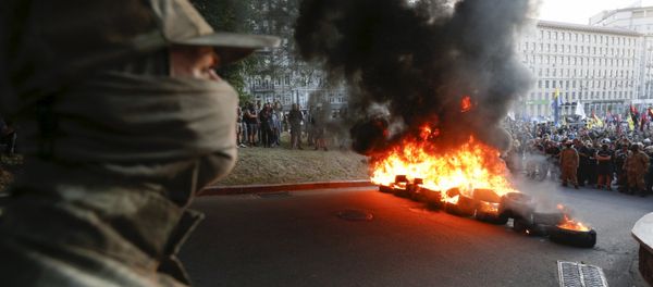Tyres are set on fire during a rally held by members of the far-right radical group Right Sector, representatives of the Ukrainian volunteer corps and their supporters in central Kiev, Ukraine, July 3, 2015 Tyres are set on fire during a rally held by members of the far-right radical group Right Sector, representatives of the Ukrainian volunteer corps and their supporters in central Kiev, Ukraine, July 3, 2015 - Sputnik International